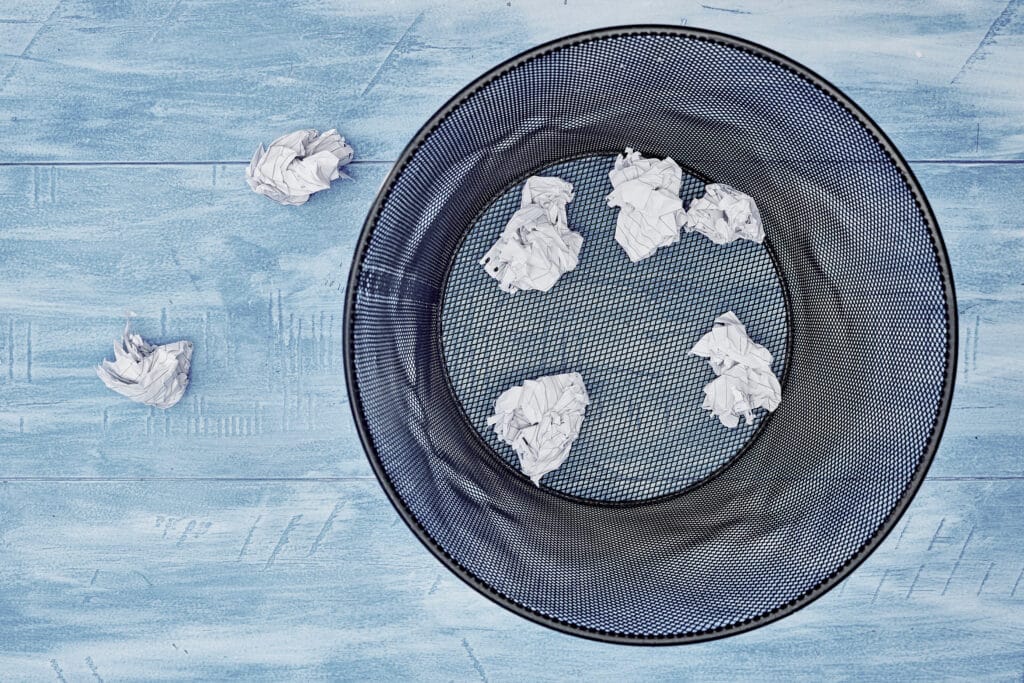 Trash bin with paper sheets